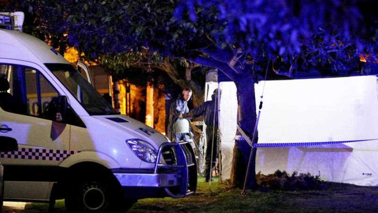 Forensic police officers are seen outside a property in Bedford, Perth.