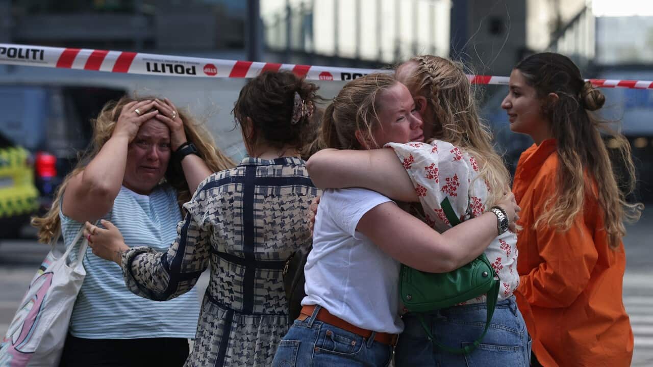 People embrace after shooting In Copenhagen