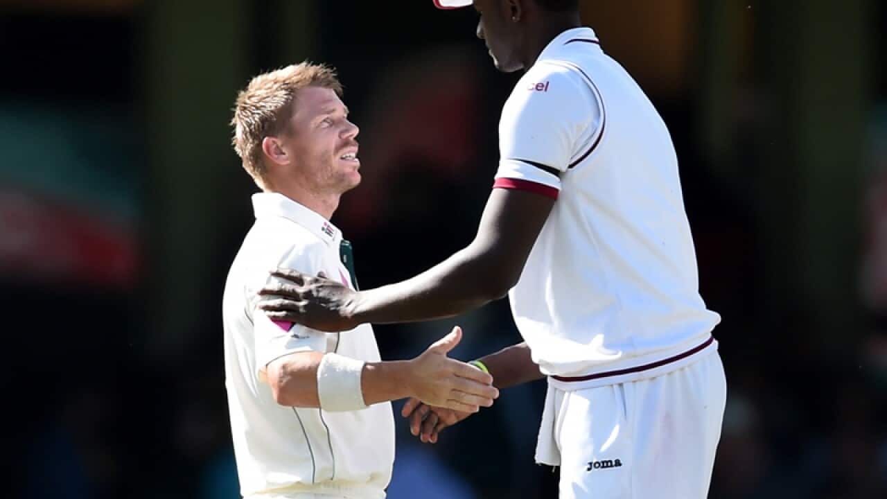 Australia's David Warner (left) shakes hands with Jason Holder.