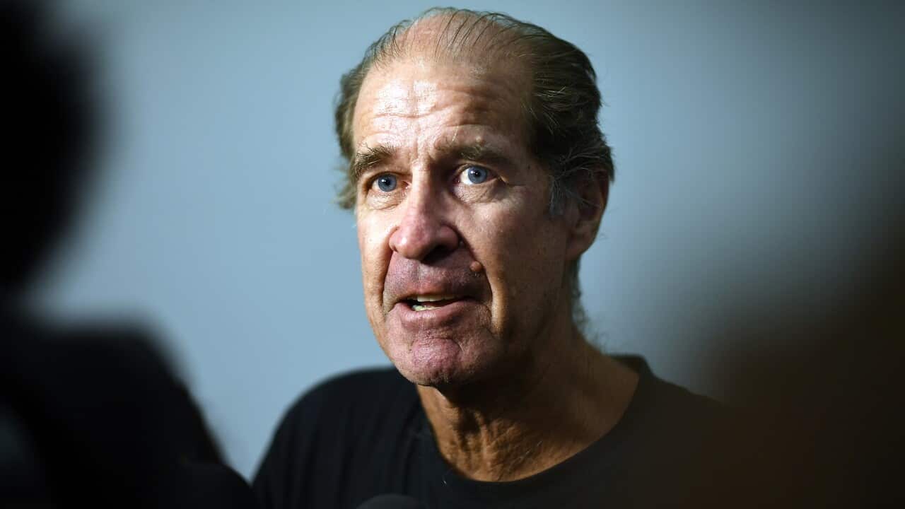 James Ricketson talks to reporters.