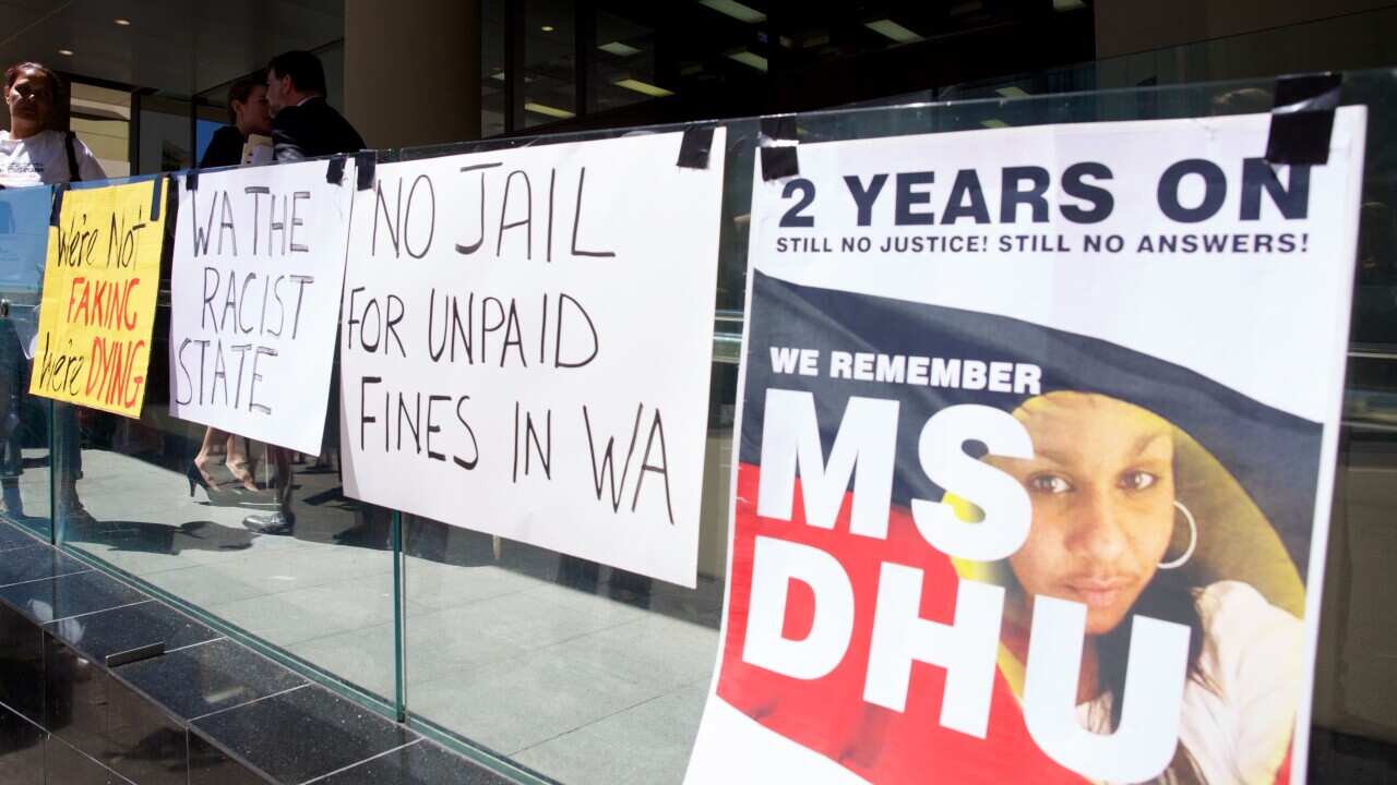 Signs put up by supporter of Ms Dhu outside the coroner's court in Perth on Friday, Dec. 16, 2016.