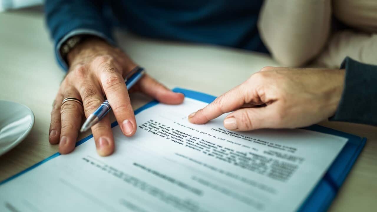 Close up of signing a mortgage contract in the office.