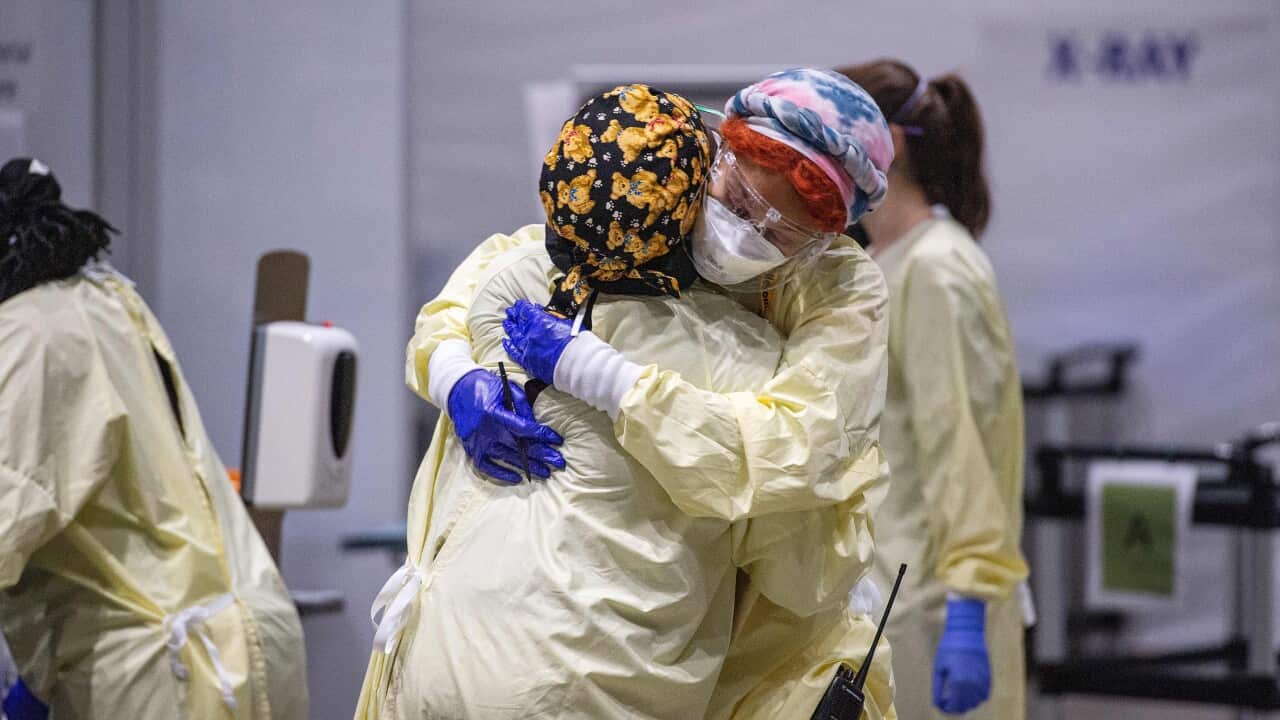 Medical workers embrace in a hospital hot zone where medical staff monitor and treat sick patients infected with COVID-19 in Massachusetts.