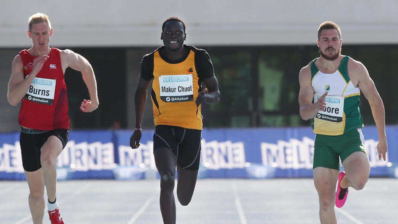 Mangar Makur Chuot (centre) wins the men's 200 metre final at the Athletics Championships and Commonwealth Games Selection Trials at Lakeside Stadium in Melbourne on Sunday, April 6, 2014. (AAP Image/David Crosling) NO ARCHIVING
