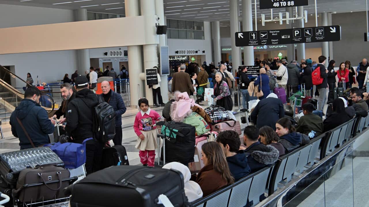 Passengers inside an airport terminal.