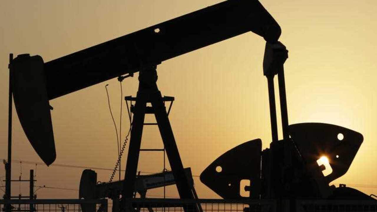 In this Sept. 30, 2015, file photo, oil pumps work in the desert oil fields of Sakhir, Bahrain.