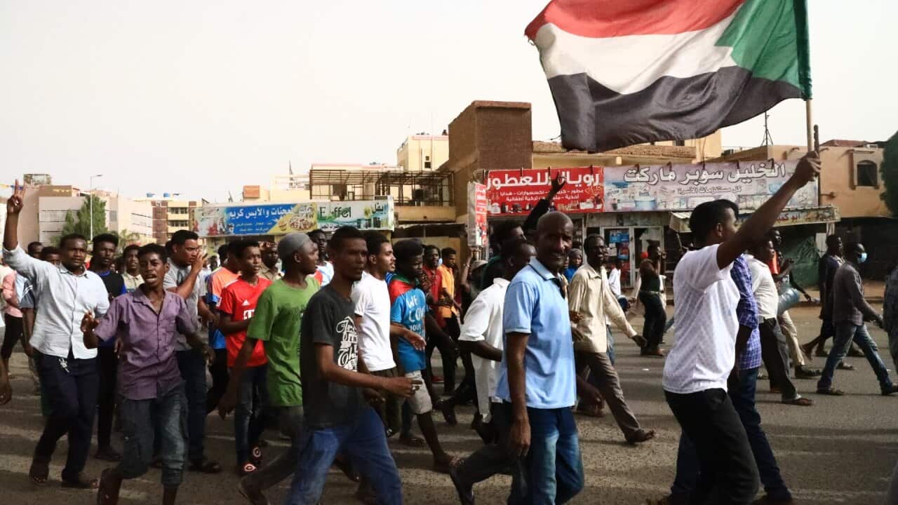 Thousands of protesters march against military rule.