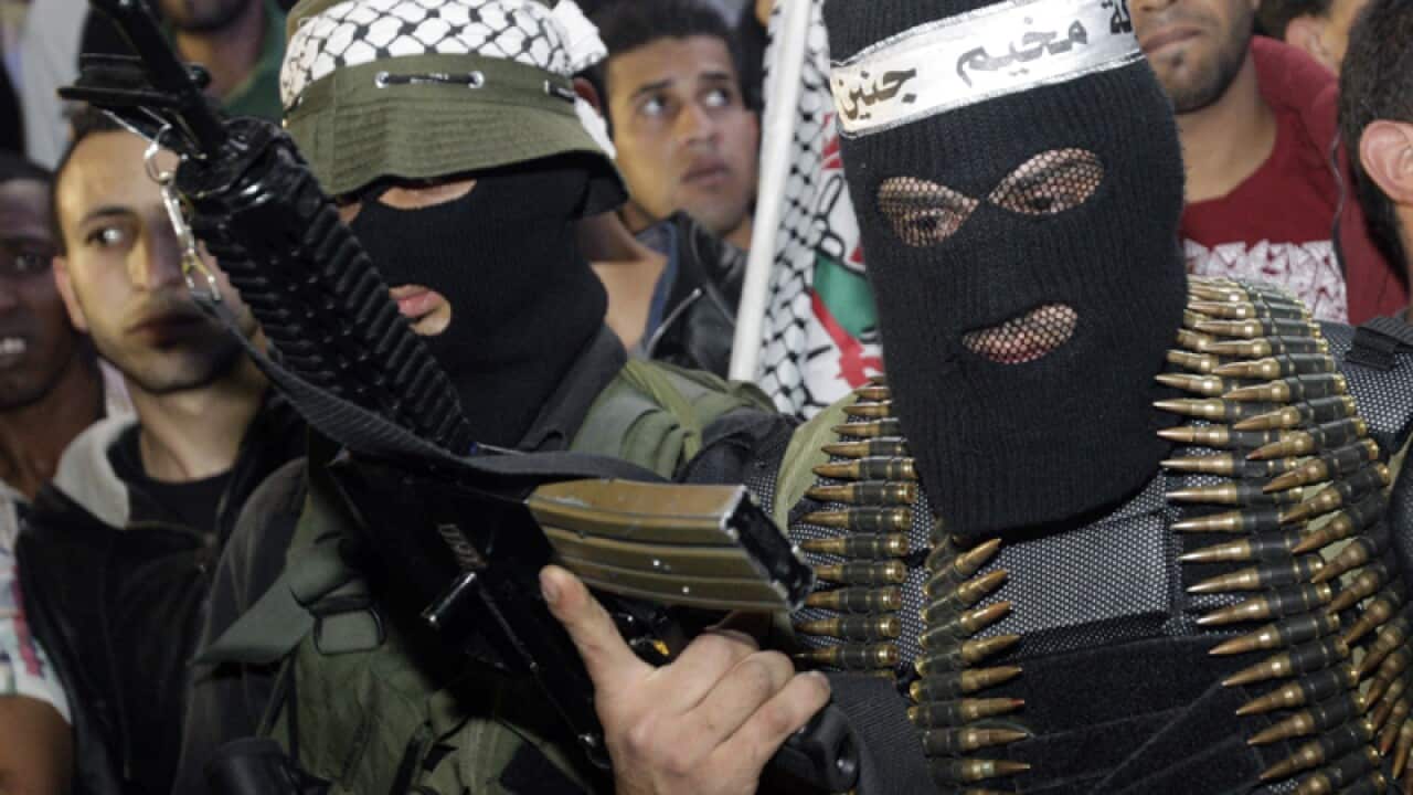 A Palestinian militant holds a weapon during an anniversary ceremony