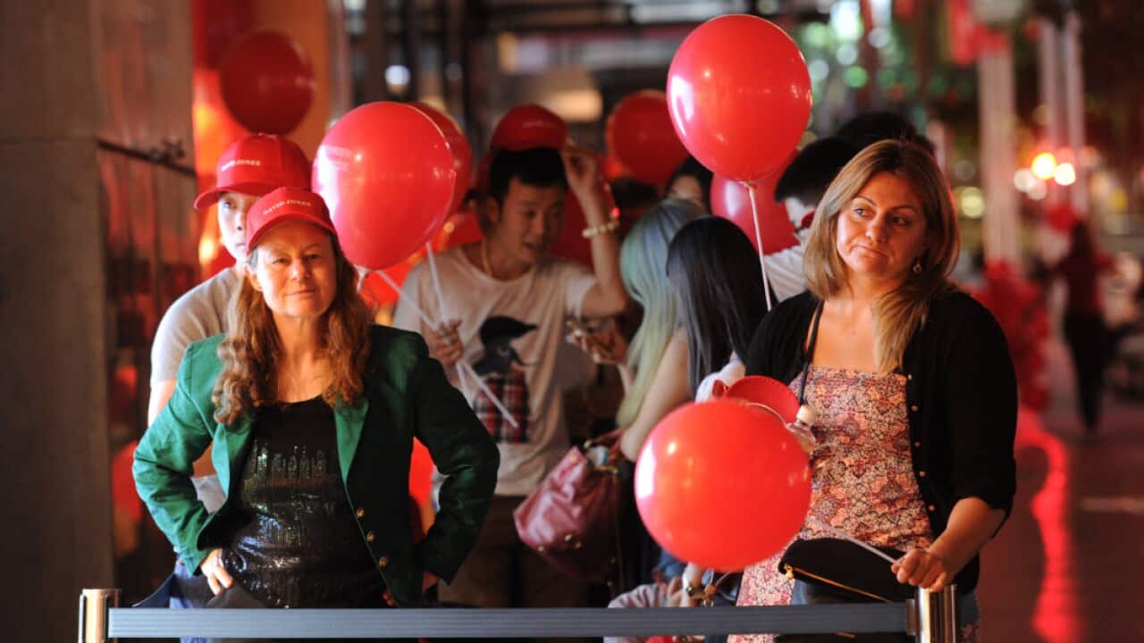 Early morning shoppers wait for David Jones Ambassador Jess Gomes to open the Boxing Day sales at 5am at the David Jones Bourke Street store in Melbourne.