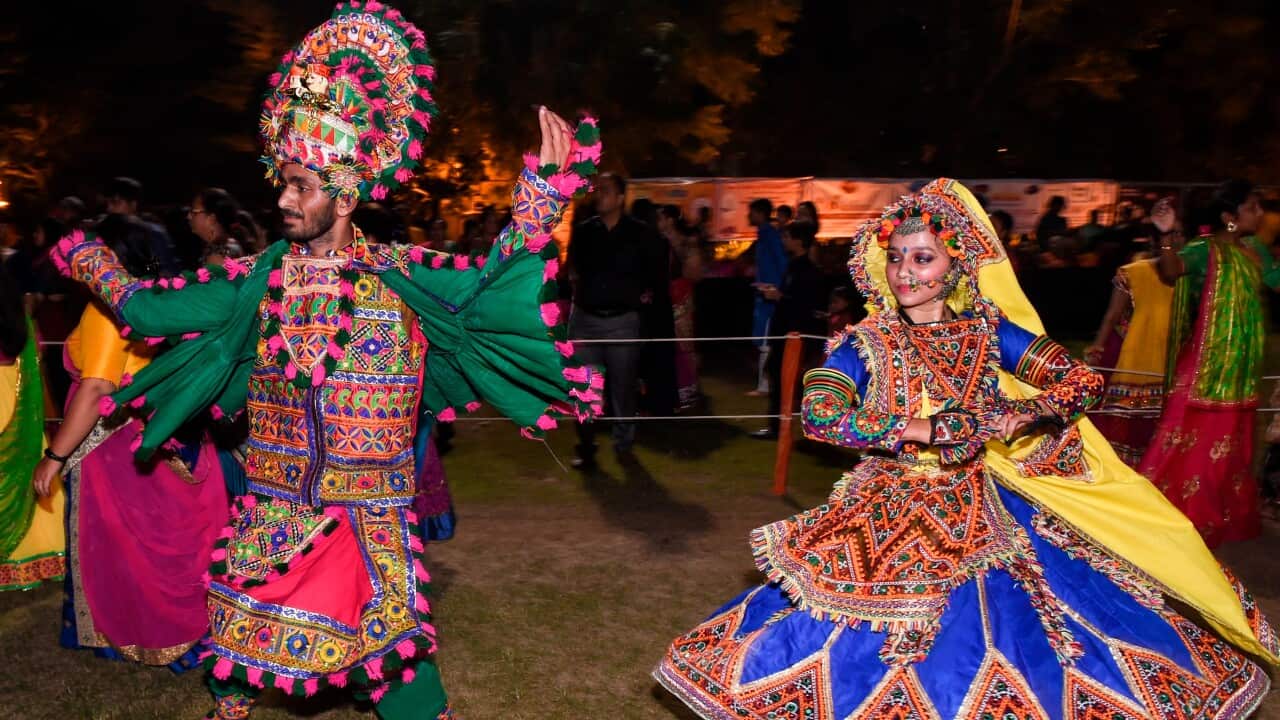 Performers take part in a Garba dance on the eve of Sharad Poornima