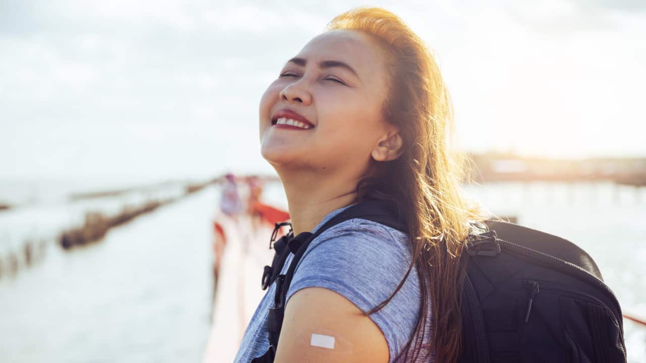 happy traveller vaccinated Getty imges .png