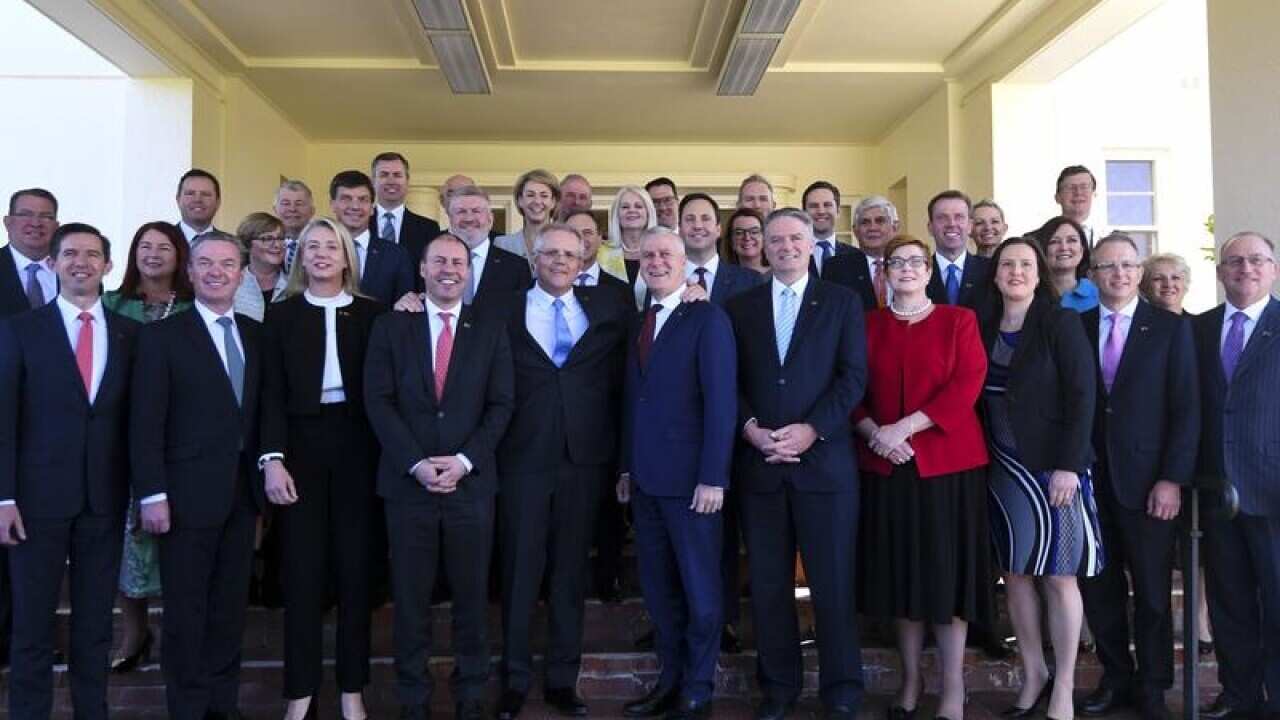 PM Scott Morrison poses for photographs with members of his ministry.