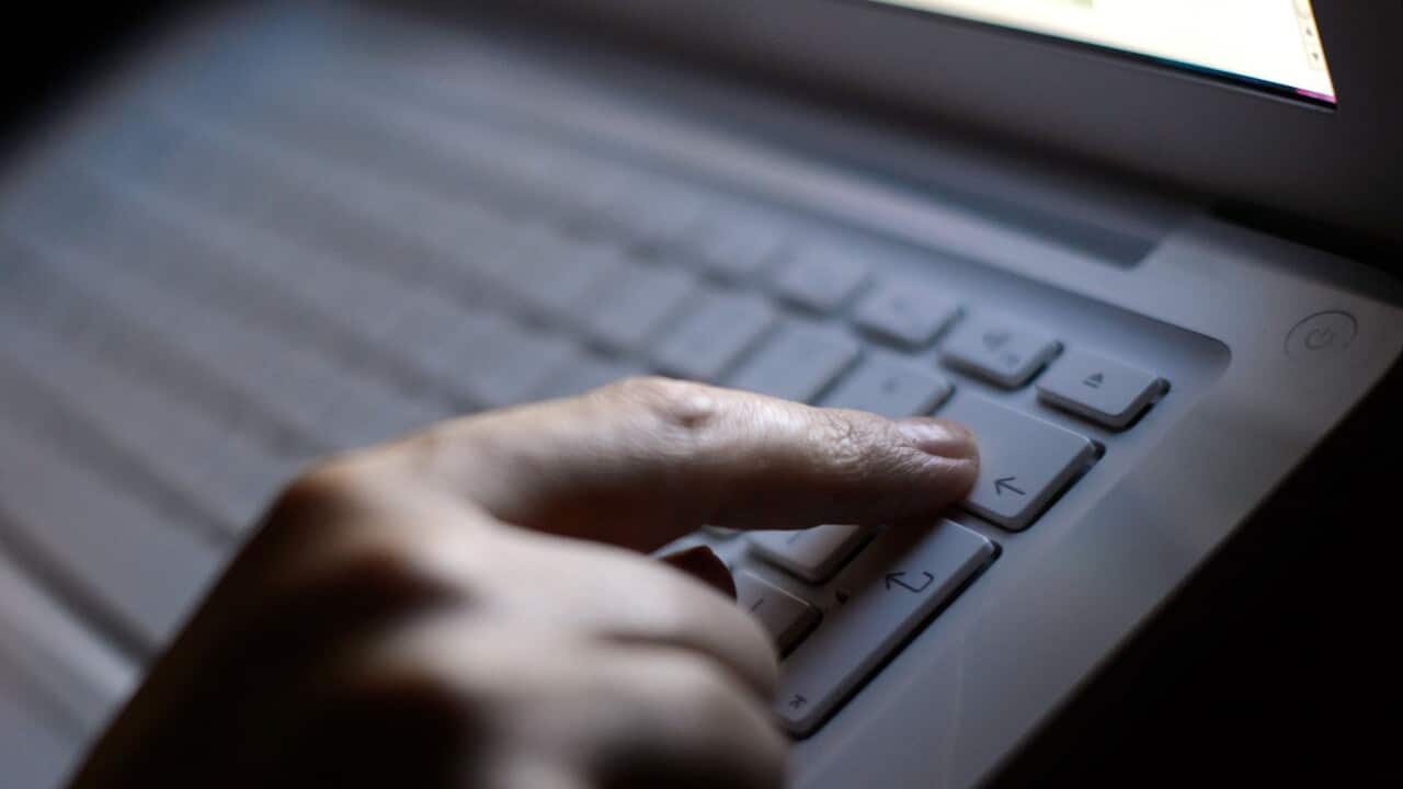 Generic stock photo shows a woman's hands using a laptop keyboard.