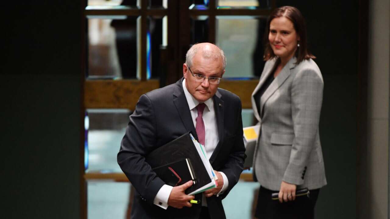 Prime Minister Scott Morrison and Minister for Jobs Kelly O'Dwyer leave after Question Time in the House of Representatives at Parliament House in Canberra.