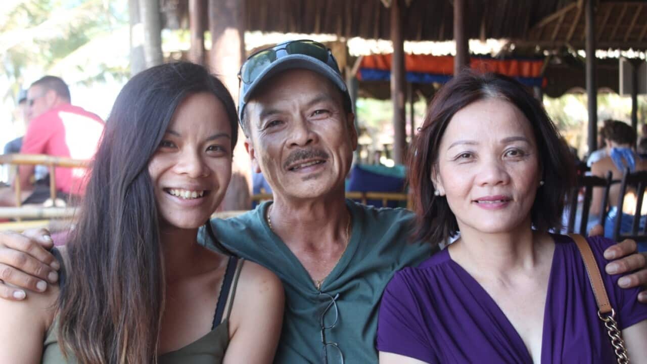 Camha Pham (left) with her parents.