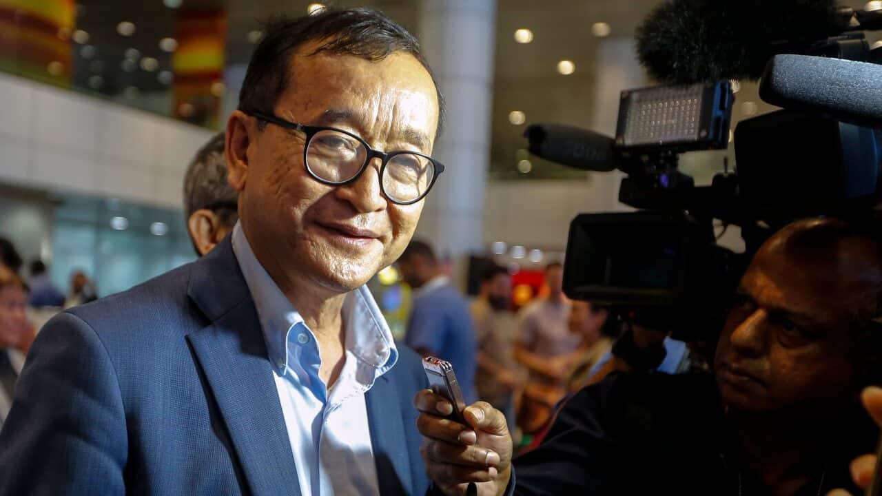 Self-exiled former Cambodian opposition leader Sam Rainsy speaks to journalists after landing at Kuala Lumpur.