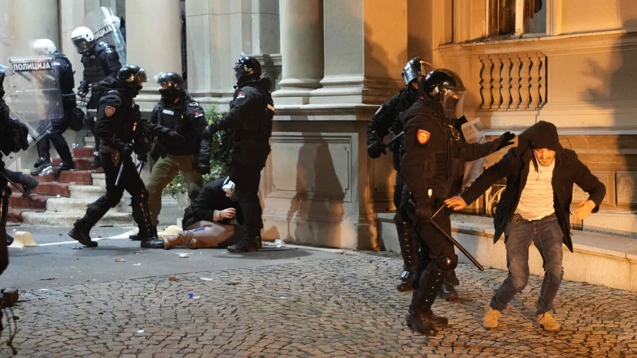 Protesters clash with anti-riot police in Belgrade, Serbia, Sunday, Dec. 24, 2023. Police in Serbia have fired tear gas to prevent hundreds of opposition supporters from entering the capital's city council building to protest what election observers said were widespread vote irregularities during a general election a week ago