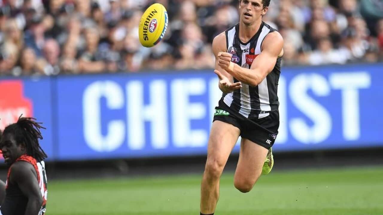 Scott Pendlebury of the Magpies (right) is seen in action.