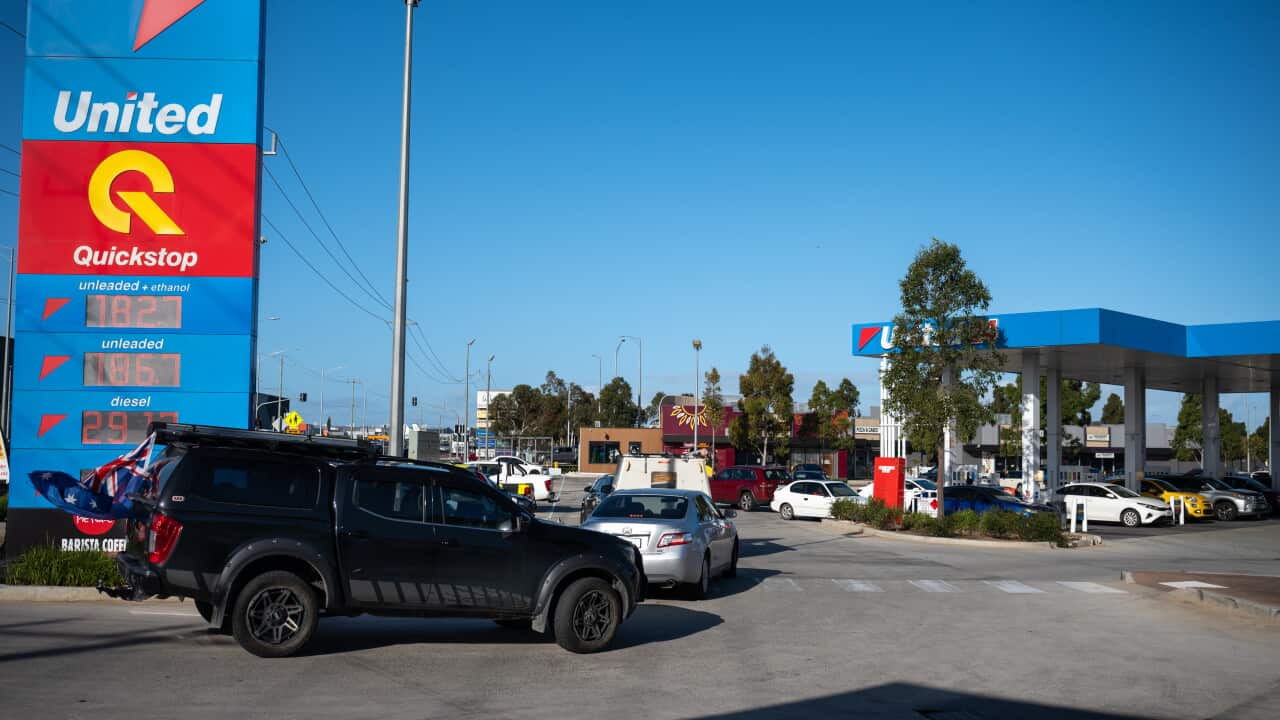 Motorists fill their vehicles with petrol for under two dollars a litre at a service station.