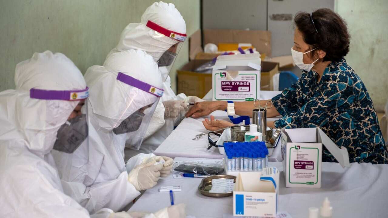 Vietnamese medical specialists collect blood samples for a coronavirus (COVID-19) rapid test (Linh Pham - Getty)