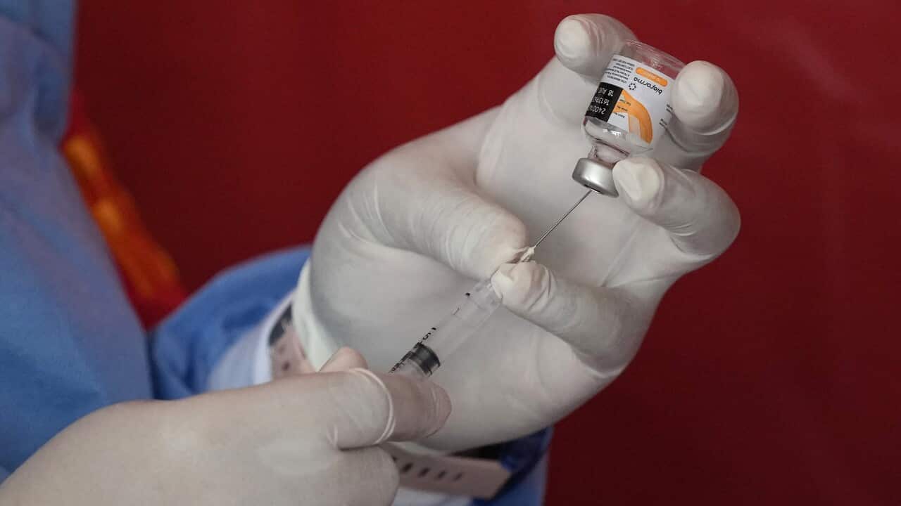 A medical worker prepares a shot of the Sinovac COVID-19.