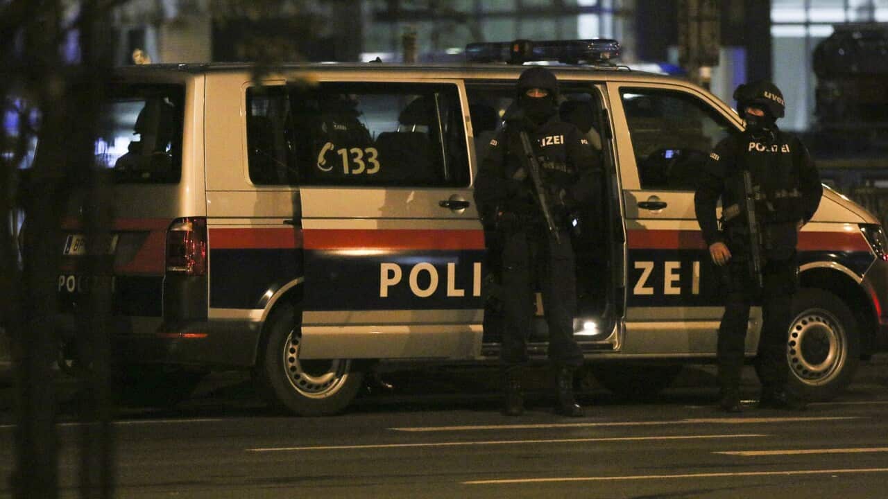 Police officers stay in position following the attack in Vienna
