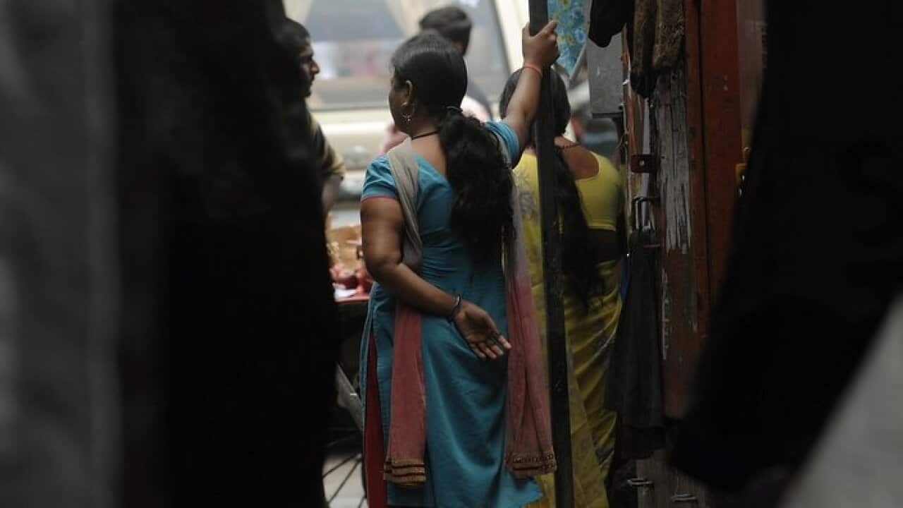 An Indian sex worker stands in the Kamathipura