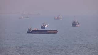 A large number of ships float in a large body of water.