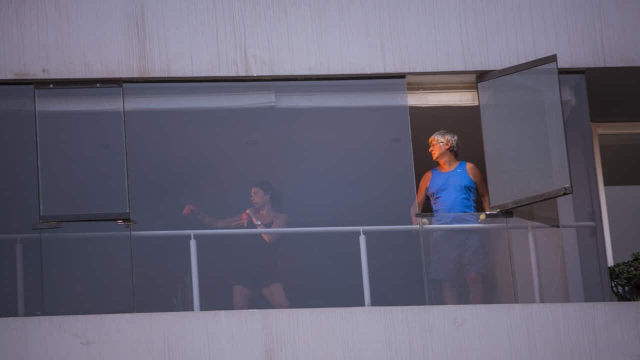 A women exercises inside her apartment in Lima, Peru, Saturday, March 21, 2020. Peru is on the sixth day of a government decreed state of emergency amid the presence of the new coronavirus and COVID-19. (AP Photo/Rodrigo Abd)