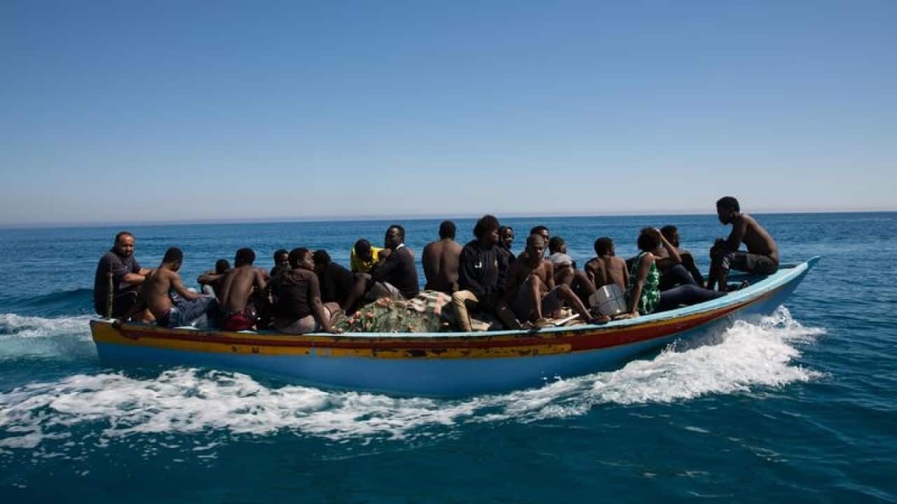 Migrants ride a boat after they were rescued.