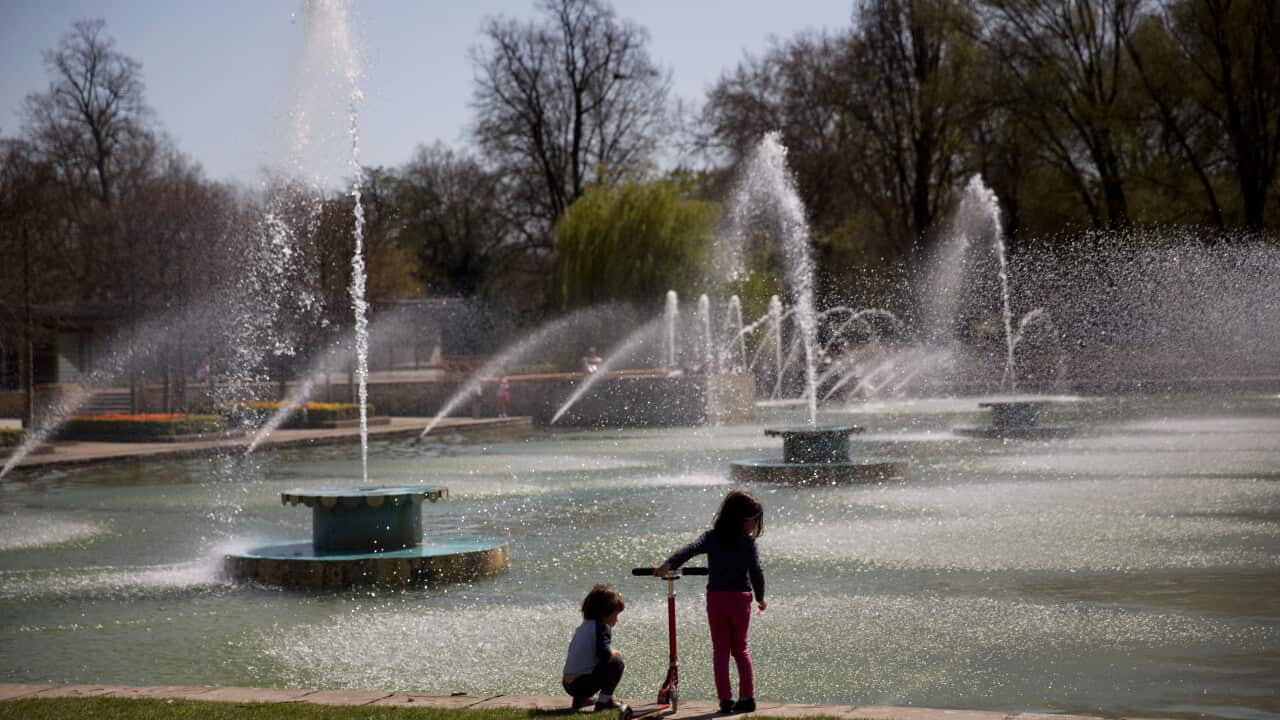 Children stand by fountains on a hot day in Battersea Park, London, Wednesday, April 15, 2015. Battersea Park, which is a 200 acre (83-hectare) green space on the south bank of the River Thames was opened in 1858. (AP Photo/Matt Dunham)