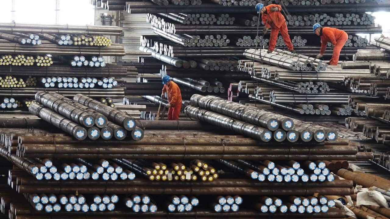 Workers transport steel bars at a plant of Dongbei Special Steel Group Co Ltd. in Dalian.
