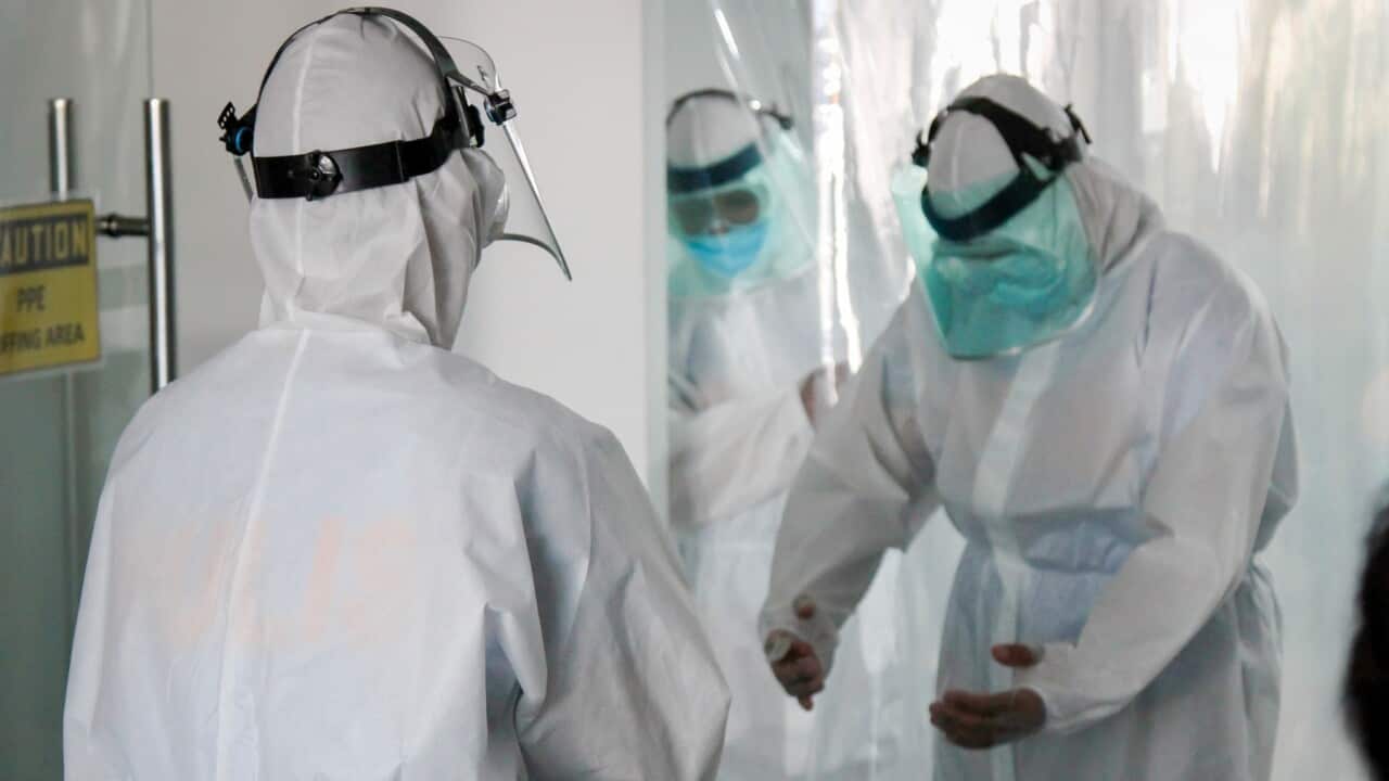 People wearing full Personal Protective Equipment
