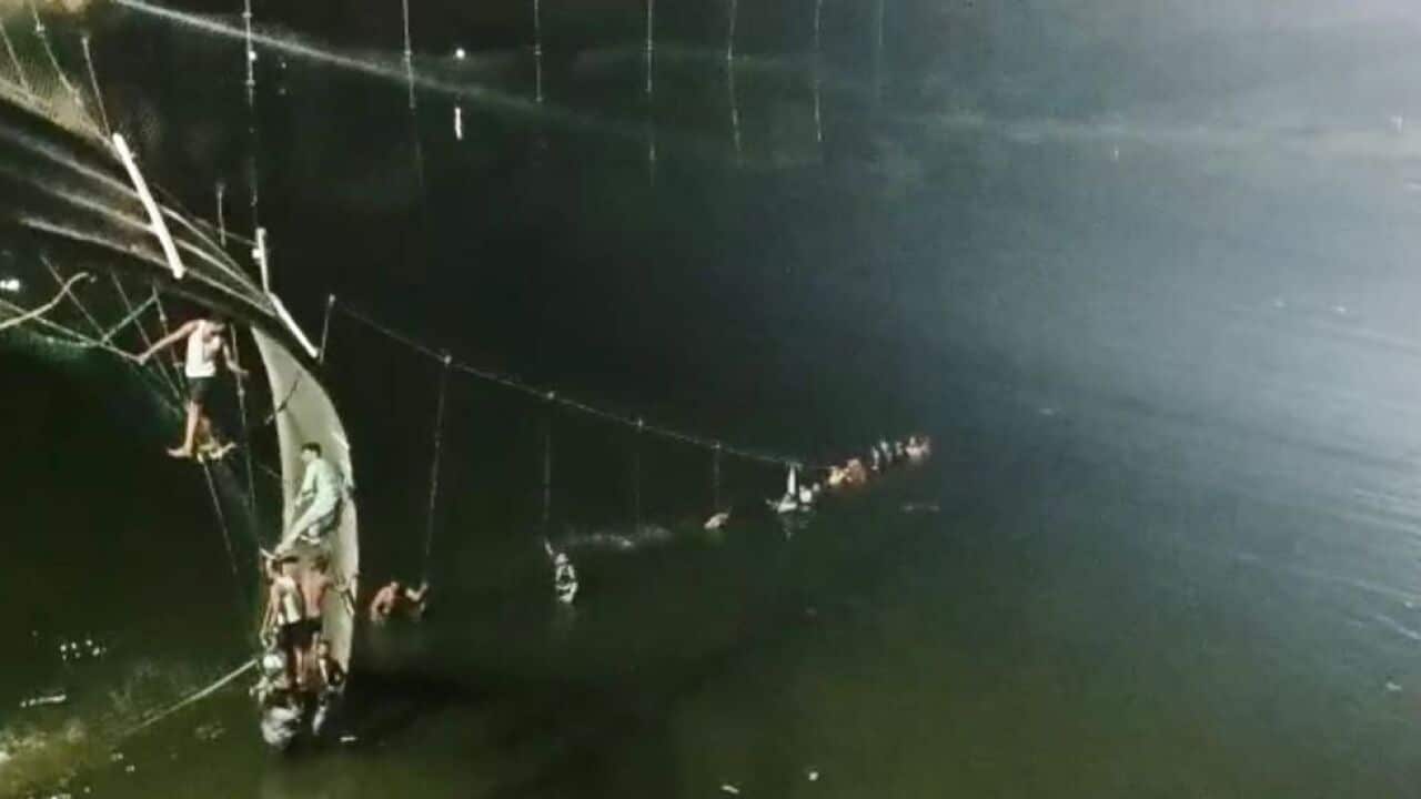 A view of the site after a suspension bridge collapses in India's Gujarat state on October 30, 2022.