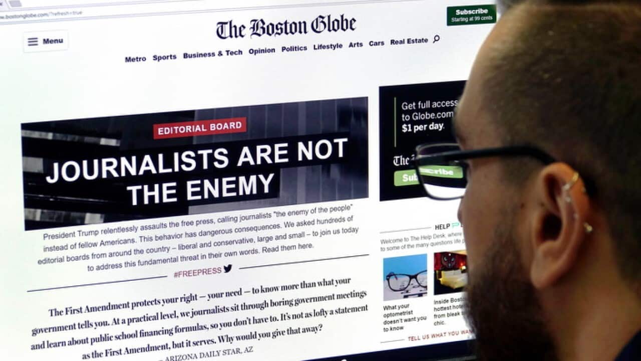 A man in Frankfurt, Germany, views the front-page of the online edition of The Boston Globe