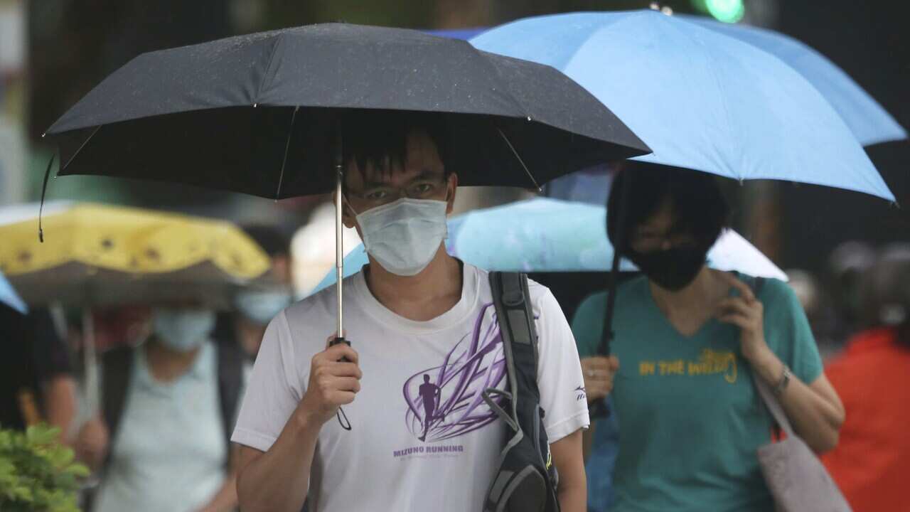 People wear face masks to protect against the spread of the coronavirus in Taipei, Taiwan, Monday, July 27, 2020. (AP Photo/Chiang Ying-ying)
