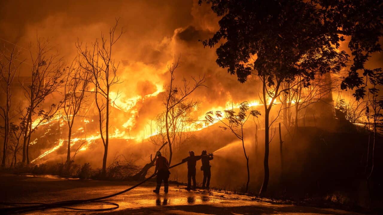 Firefighters try to contain a fire at a warehouse facility during a wild fire near Oraiokastro, on the northwest outskirts of Thessaloniki (Konstantinos Tsakalidis-Bloomberg via Getty Images).jpg