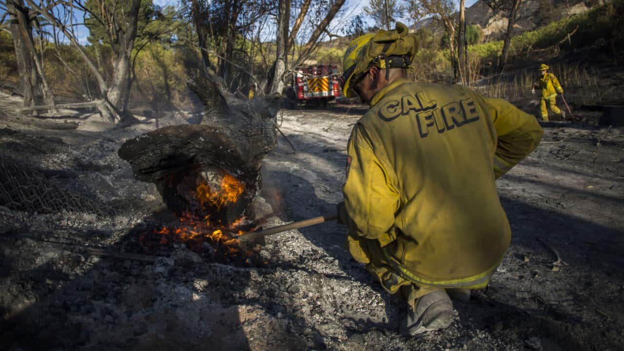 A firefighter controls a hotspot of the Maria Fire, in Santa Paula, Ventura County, California.