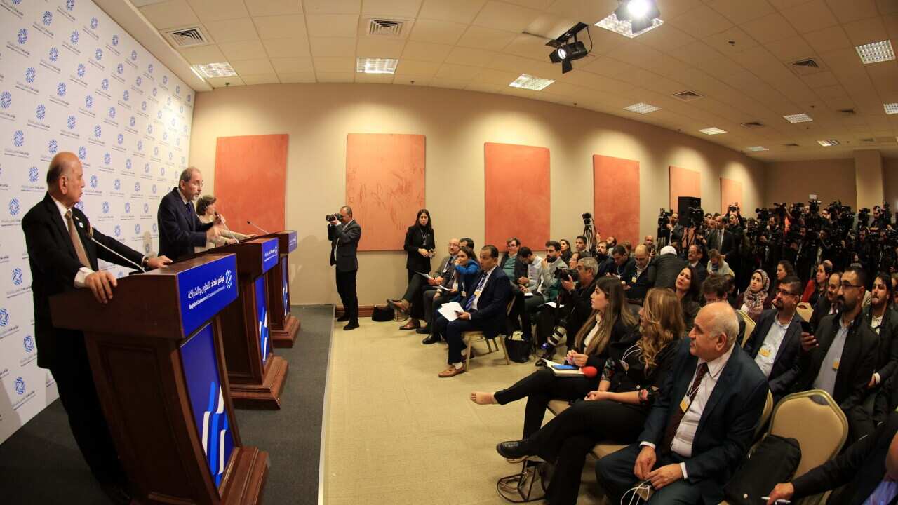 Delegates speak to the press at the end of the Baghdad conference