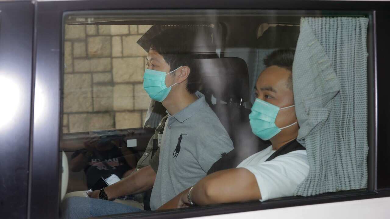 Pro-democracy politician Ted Hui (centre) is arrested by police officers in Hong Kong.