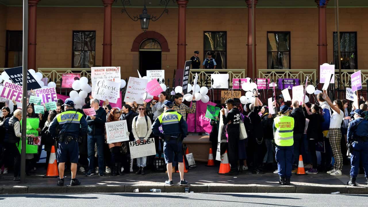 Opposing groups protest outside the New South Wales parliament as abortion legislation is debated.