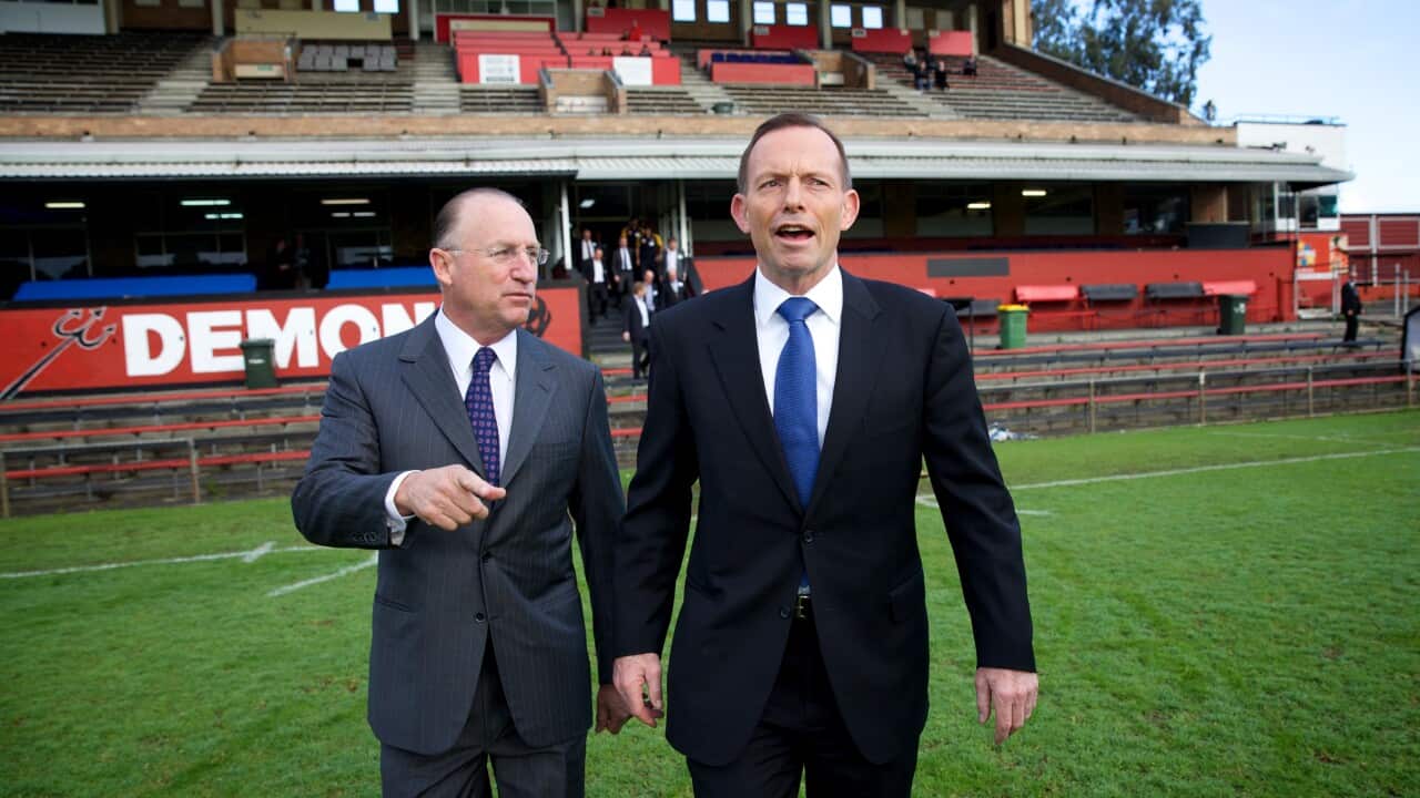 Australian Prime Minister Tony Abbott (right) walking with Steve Irons MP for Swan at Lathlain Oval, Saturday, Aug, 22, 2015.
