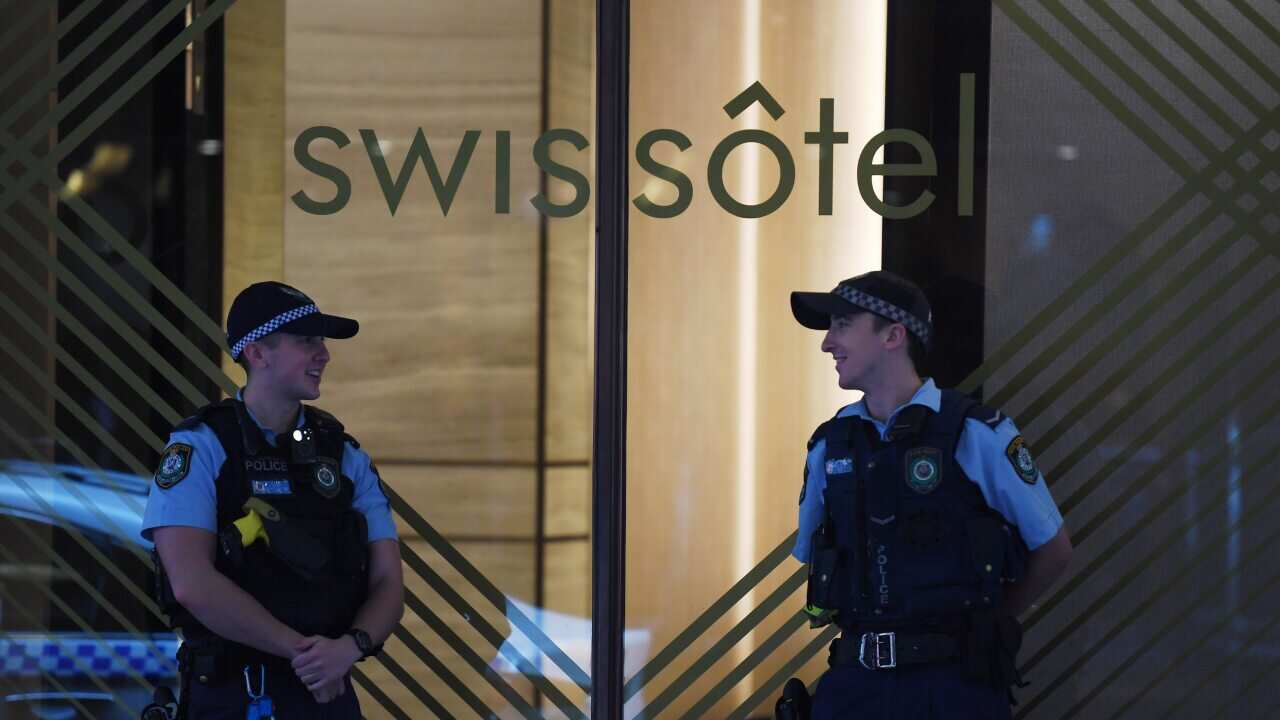 NSW Police stand guard outside the Swissotel Hotel in Market Street, Sydney.
