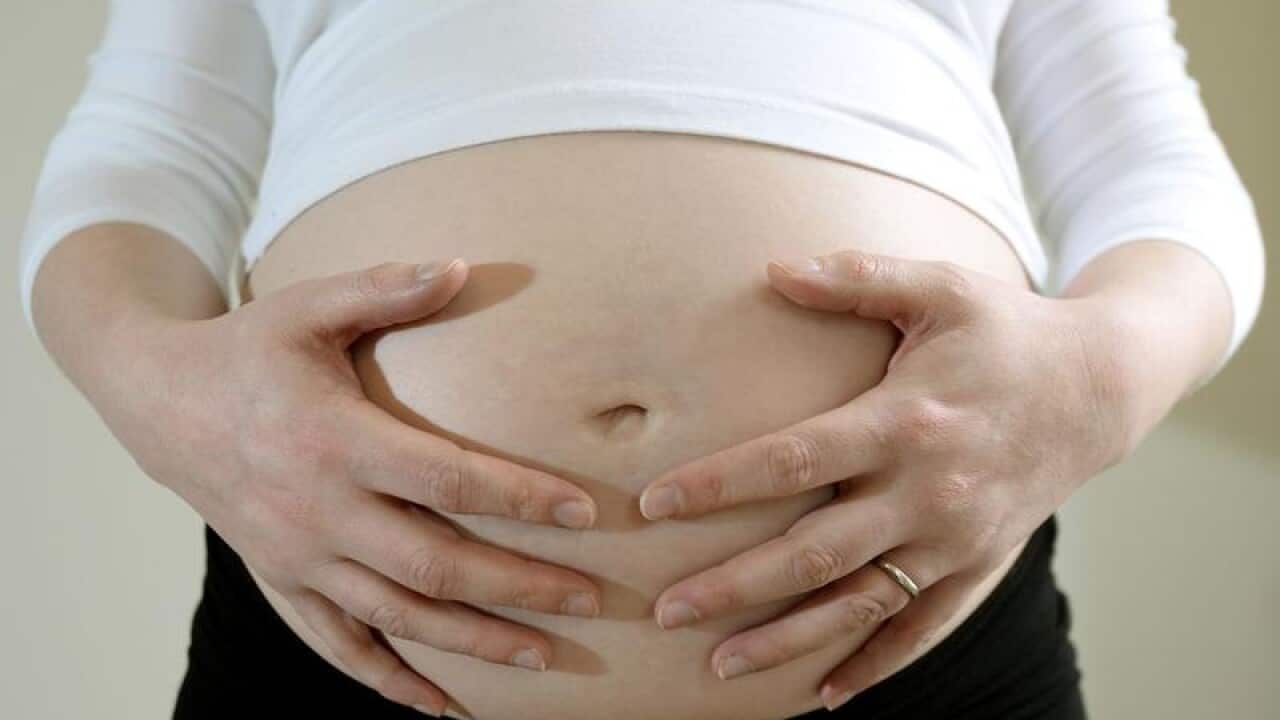 A pregnant woman.
