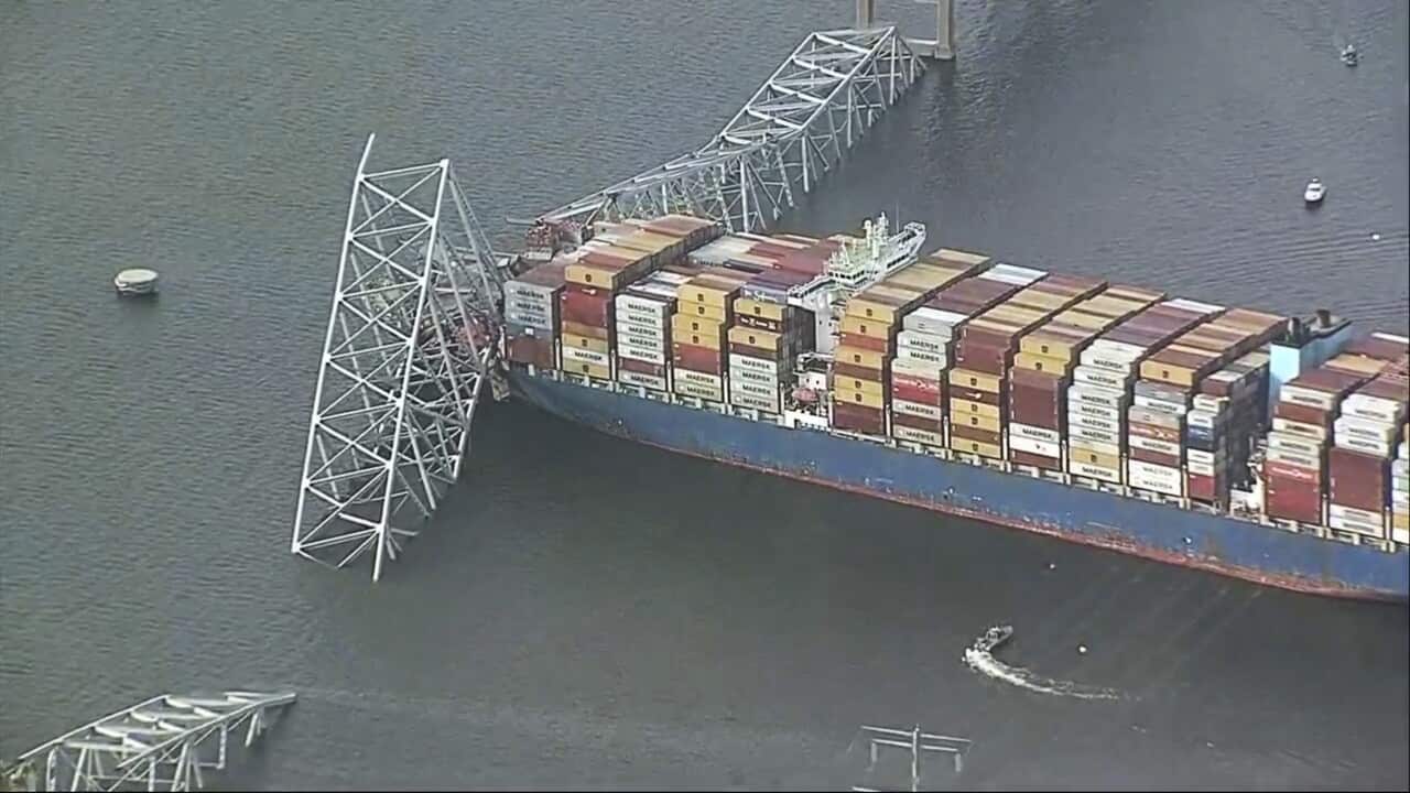 A container ship running into a bridge