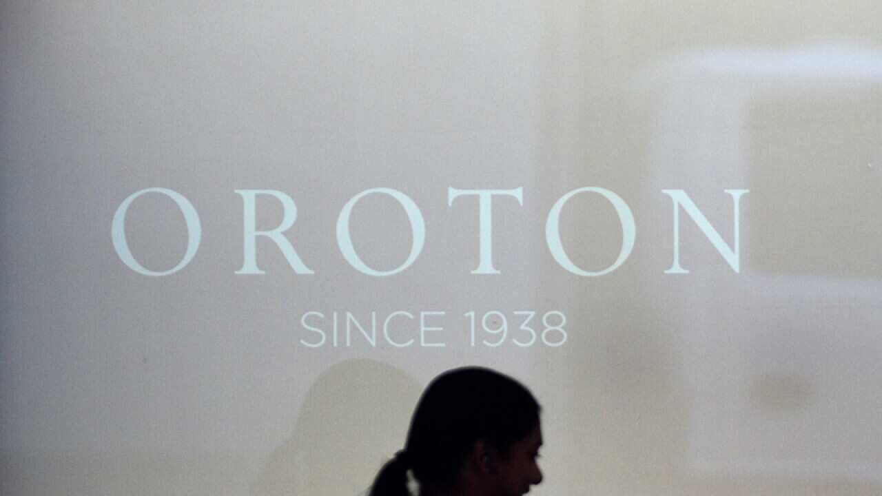 A woman walks past an Oroton luxury fashion accessories store.