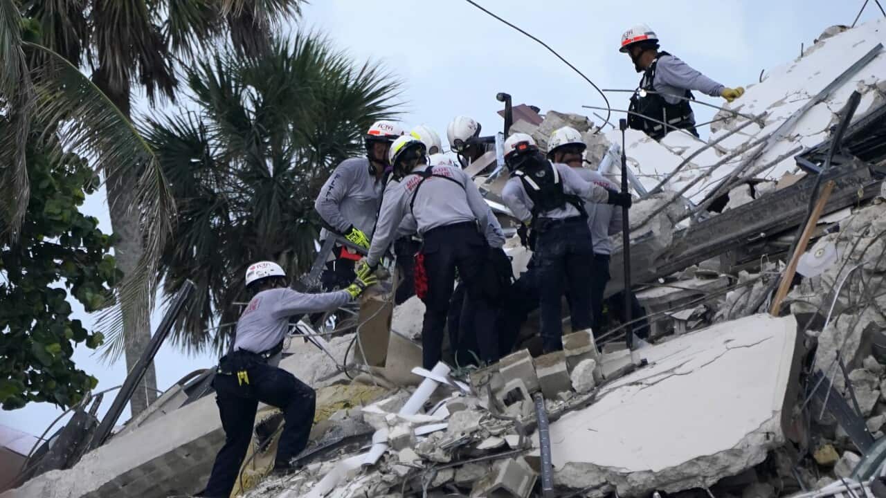 Rescue workers look through the rubble.