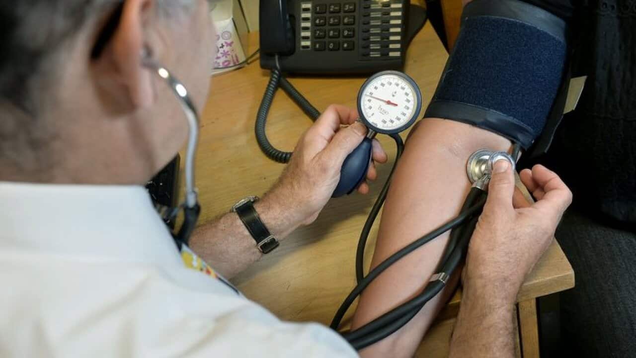 doctor checking a patient's blood pressure