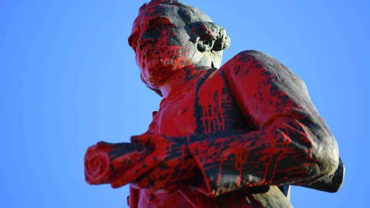 Red paint is seen covering a vandalised statue of Captain James Cook at Catani Gardens in St Kilda, Melbourne, Wednesday, January 26. 2022.