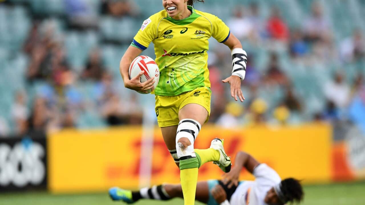 Chloe Dalton of Australia makes a break to score a try